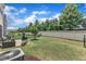 Landscaped backyard with green lawn, patio, grill, and privacy fence at 2969 Thirlestane Dr, Apex, NC 27502
