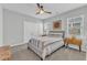 Comfortable bedroom with neutral walls, ceiling fan, and natural light from the windows at 2969 Thirlestane Dr, Apex, NC 27502