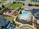 Aerial shot of the community pool, playground, and lounge areas near residential houses at 2969 Thirlestane Dr, Apex, NC 27502