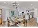 Elegant dining area with modern lighting, seamlessly connected to the kitchen and living room at 2969 Thirlestane Dr, Apex, NC 27502