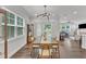 Lovely dining room with a stylish light fixture and an open view of the kitchen and living spaces at 2969 Thirlestane Dr, Apex, NC 27502