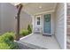 Inviting front porch with a seating bench, wreath-adorned blue door, and stone accents at 2969 Thirlestane Dr, Apex, NC 27502