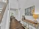 Bright hallway with hardwood floors, neutral walls, and decorative console table at 2969 Thirlestane Dr, Apex, NC 27502
