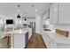 Spacious kitchen with white cabinets, stainless steel appliances, a center island, and hardwood floors at 2969 Thirlestane Dr, Apex, NC 27502