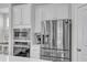 Kitchen featuring stainless steel refrigerator, built-in microwave/oven, and white cabinets at 2969 Thirlestane Dr, Apex, NC 27502