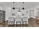 Kitchen island with bar seating, stainless steel appliances, and white cabinetry at 2969 Thirlestane Dr, Apex, NC 27502