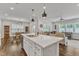 Open-concept kitchen with a large island, pendant lighting, and views into the dining and living areas at 2969 Thirlestane Dr, Apex, NC 27502
