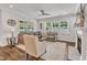Beautiful living room with modern decor, a gray sofa, and large windows providing natural light at 2969 Thirlestane Dr, Apex, NC 27502