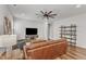 Living room boasts a ceiling fan, TV, and decor shelving, creating a stylish and comfortable space at 2969 Thirlestane Dr, Apex, NC 27502