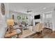 Bright living room featuring a comfortable sectional sofa, fireplace, ceiling fan, and large windows at 2969 Thirlestane Dr, Apex, NC 27502