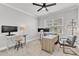 Home office with an adjustable desk, multiple monitors, and neutral decor at 2969 Thirlestane Dr, Apex, NC 27502