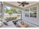 Inviting screened-in porch with comfortable seating and a ceiling fan for relaxing outdoors at 2969 Thirlestane Dr, Apex, NC 27502