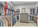 Spacious walk-in closet with ample shelving and a dresser for storage at 2969 Thirlestane Dr, Apex, NC 27502
