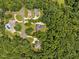 A birds eye view of beautiful homes surrounded by mature trees and professional landscaping at 305 Lochridge Dr, Roxboro, NC 27573