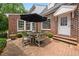 Backyard patio with brick pavers, table, and chairs at 305 Lochridge Dr, Roxboro, NC 27573