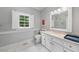 Bathroom featuring marble floors, granite countertop, and modern fixtures at 305 Lochridge Dr, Roxboro, NC 27573