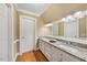 Bathroom featuring double sinks with granite counters, and crisp white cabinets and trim at 305 Lochridge Dr, Roxboro, NC 27573