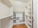 Walk-in closet with built in shelves and drawers, as well as hardwood floors at 305 Lochridge Dr, Roxboro, NC 27573