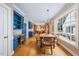 Open dining room with wood floors, blue cabinetry, and large window offering ample natural light at 305 Lochridge Dr, Roxboro, NC 27573
