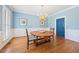 Charming dining room with blue walls, hardwood floors, and natural light at 305 Lochridge Dr, Roxboro, NC 27573