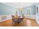 Bright dining room featuring hardwood floors and a round wooden table at 305 Lochridge Dr, Roxboro, NC 27573