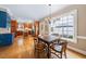 Dining area with wood floors and a large window offering a view of the backyard at 305 Lochridge Dr, Roxboro, NC 27573