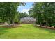 Charming brick home with a large front yard and mature trees at 305 Lochridge Dr, Roxboro, NC 27573