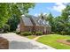 Attractive brick home with a long driveway and well-maintained bushes at 305 Lochridge Dr, Roxboro, NC 27573