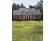 Charming brick home with dormer windows and a well-manicured lawn at 305 Lochridge Dr, Roxboro, NC 27573