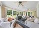Sunroom with neutral furniture, large windows, and ceiling fans for a relaxing space at 305 Lochridge Dr, Roxboro, NC 27573