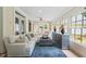 Sun-filled living room with tile floors, neutral couches, and multiple windows at 305 Lochridge Dr, Roxboro, NC 27573