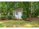 Garden shed with wood shake roof and painted siding at 305 Lochridge Dr, Roxboro, NC 27573