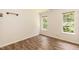 Bright bedroom featuring luxury vinyl plank flooring and two windows at 3110 Trinness Dr, Durham, NC 27707