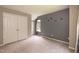 Carpeted bedroom with double door closet and painted accent wall at 3110 Trinness Dr, Durham, NC 27707