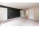 Spacious bedroom with a modern accent wall, plush carpet, and bright, white doors at 3110 Trinness Dr, Durham, NC 27707