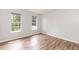 Well-lit bedroom featuring durable LVP flooring and two bright windows at 3110 Trinness Dr, Durham, NC 27707