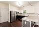 Modern kitchen features stainless steel appliances, granite countertops, and white cabinets with black lower cabinets at 3110 Trinness Dr, Durham, NC 27707