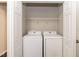 Convenient laundry room closet with a wire shelf above a modern Samsung washer and dryer set at 3110 Trinness Dr, Durham, NC 27707