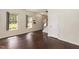 A sun-lit living room features gleaming hardwood floors and neutral paint at 3110 Trinness Dr, Durham, NC 27707