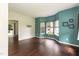Open-concept living room with hardwood floors and large bay windows at 3110 Trinness Dr, Durham, NC 27707