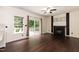 Spacious living room with hardwood floors, a fireplace, ceiling fan, and a sliding glass door to the deck at 3110 Trinness Dr, Durham, NC 27707