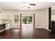 Inviting living room with hardwood floors, ceiling fan, and sliding glass doors leading to outdoor deck at 3110 Trinness Dr, Durham, NC 27707