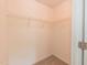 A walk-in closet with neutral walls, tan carpet, and wire rack shelves at 3110 Trinness Dr, Durham, NC 27707