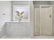 Bright bathroom featuring a shower with glass doors and stylish white cabinets at 33 Bluestone Dr, Smithfield, NC 27577