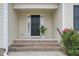 Inviting front entrance with brick steps, sidelights, and decorative potted plant at 33 Bluestone Dr, Smithfield, NC 27577