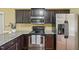 Bright kitchen featuring stainless steel appliances, granite countertops, and sleek dark cabinets, offering a modern cooking experience at 33 Bluestone Dr, Smithfield, NC 27577