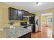 Well-lit kitchen featuring stainless steel appliances, granite countertops and dark cabinets, great for cooking and entertaining at 33 Bluestone Dr, Smithfield, NC 27577