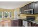 Well-lit kitchen featuring stainless steel appliances, granite countertops and dark cabinets, great for cooking and entertaining at 33 Bluestone Dr, Smithfield, NC 27577