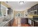 Spacious kitchen features stainless steel appliances, granite countertops, and dark cabinets, great for entertaining and cooking at 33 Bluestone Dr, Smithfield, NC 27577