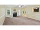 Inviting living room with fireplace, light-colored walls, and access to a sunroom at 33 Bluestone Dr, Smithfield, NC 27577